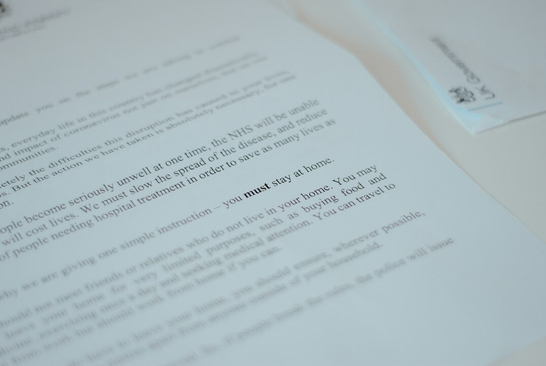 Stack of official documents with a magnifying glass