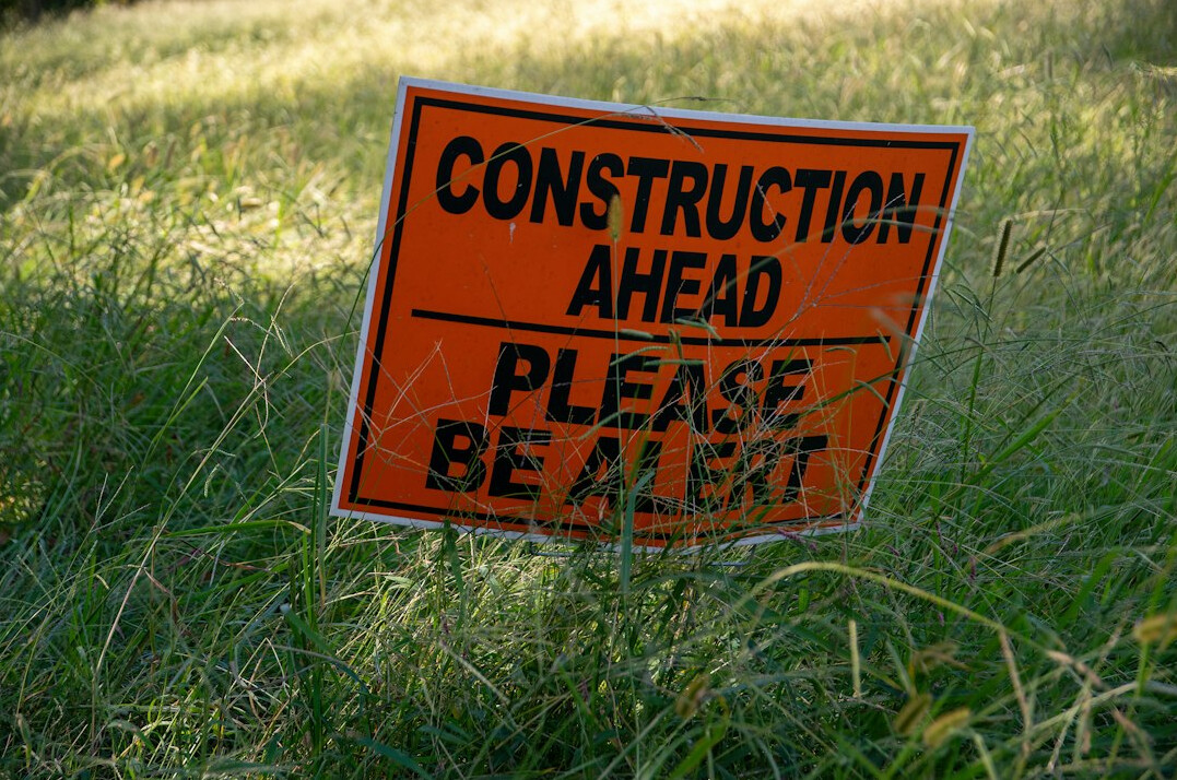 Warning sign in a protected natural dune area under construction