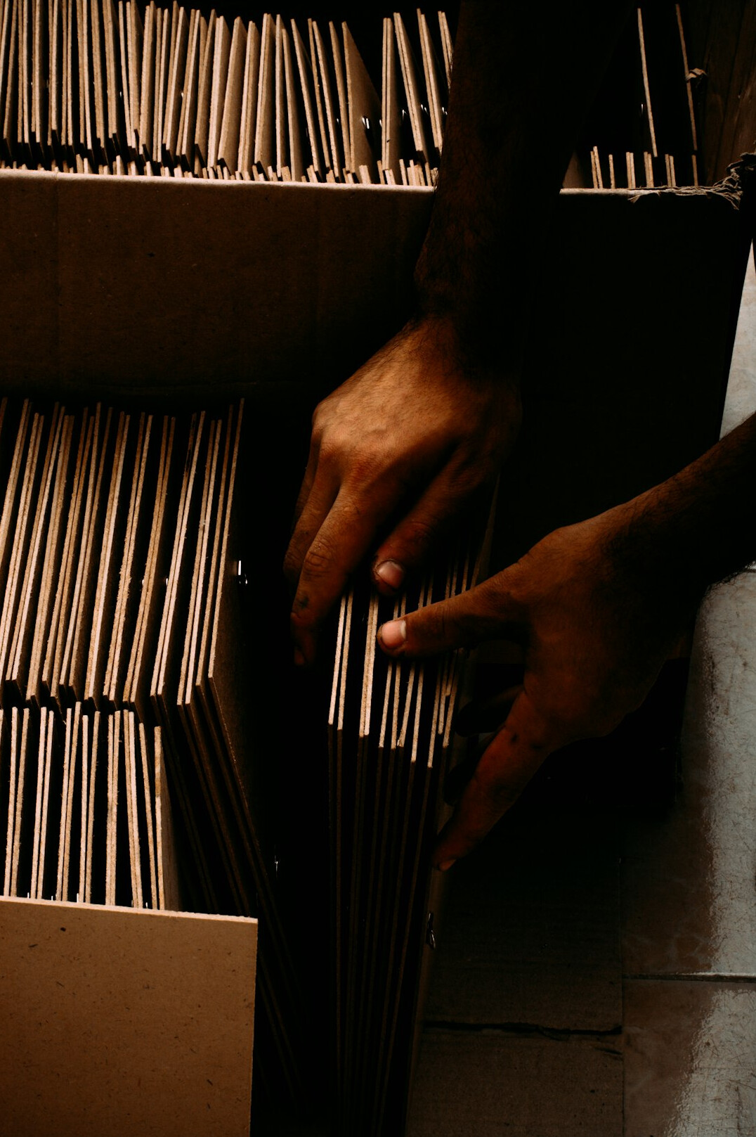 hands holding recycled cardboard box